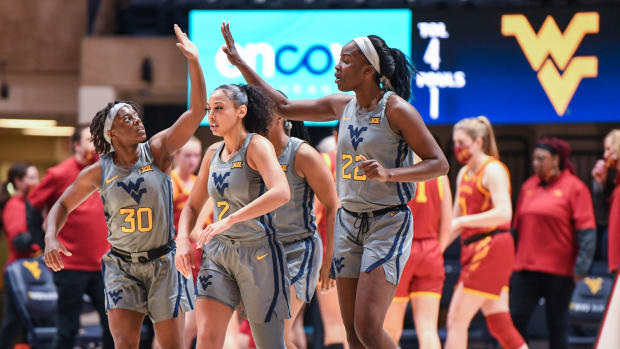 West Virginia guards Madisen Smith (30) and Kysre Gondrezick (2) and Center Blessing Ejiofer (22).